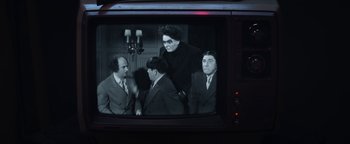 Movie still from “Zeroville” (2019), directed by James Franco – A group of men standing on top of a television; Medium shot, Over the shoulder angle