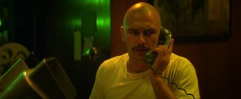 Movie still from “Zeroville” (2019), directed by James Franco – A bald man holding a phone up to his ear; Close Up shot, Low angle