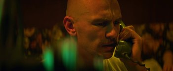 Movie still from “Zeroville” (2019), directed by James Franco – A bald man with a bald head talking on a cell phone; Close Up shot, Low angle