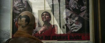 Movie still from “Zeroville” (2019), directed by James Franco – A man standing in front of a poster of a woman; Extreme Close Up shot, Over the shoulder angle
