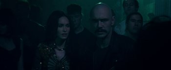 Movie still from “Zeroville” (2019), directed by James Franco – A group of people standing in a dark room; Close Up shot, Over the shoulder angle