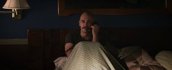 Movie still from “Zeroville” (2019), directed by James Franco – A man with a mustache talking on a phone; Medium shot, High angle