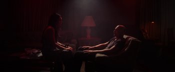 Movie still from “Zeroville” (2019), directed by James Franco – A man and a woman sitting in a dark room; Medium shot, Low angle