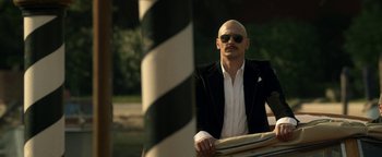 Movie still from “Zeroville” (2019), directed by James Franco – A bald man in a black suit and white shirt; Medium shot, Low angle