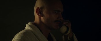 Movie still from “Zeroville” (2019), directed by James Franco – A man with a beard is talking on a phone; Close Up shot, Low angle
