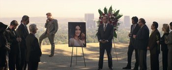 Movie still from “Zeroville” (2019), directed by James Franco – A man standing in front of a picture of a woman; Wide shot, Over the shoulder angle