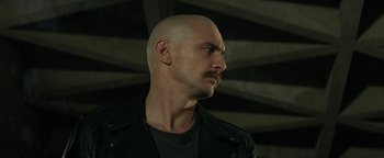Movie still from “Zeroville” (2019), directed by James Franco – A man with a bald head is looking to his left; Close Up shot, Low angle