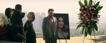 Movie still from “Zeroville” (2019), directed by James Franco – A man standing in front of a picture of a woman; Wide shot, Over the shoulder angle