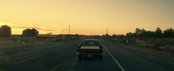 Movie still from “Zeroville” (2019), directed by James Franco – A car driving down a street at sunset; Extreme Wide shot, Low angle