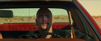 Movie still from “Zeroville” (2019), directed by James Franco – A man with a mustache driving in a car; Close Up shot, Low angle