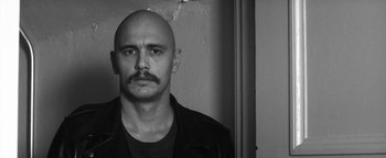Movie still from “Zeroville” (2019), directed by James Franco – Black and white photograph of a man with a mustache; Close Up shot, Low angle