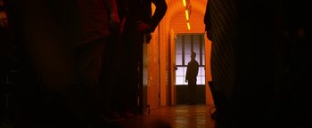 Movie still from “Zeroville” (2019), directed by James Franco – A man standing in a doorway in a building; Wide shot, Low angle