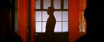 Movie still from “Zeroville” (2019), directed by James Franco – A man standing in front of an open window; Medium shot, Low angle