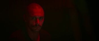 Movie still from “Zeroville” (2019), directed by James Franco – A man with a bald head is looking at the camera; Close Up shot, Low angle