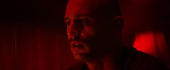 Movie still from “Zeroville” (2019), directed by James Franco – A man with a bald head is looking at the camera; Close Up shot, Low angle
