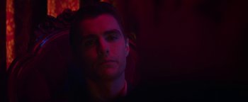 Movie still from “Zeroville” (2019), directed by James Franco – A young man in a dark room with red lighting; Close Up shot, Over the shoulder angle