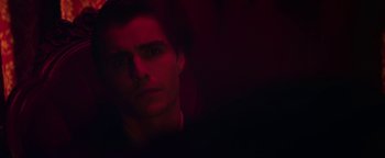 Movie still from “Zeroville” (2019), directed by James Franco – A young man is in a dark room with a red light; Close Up shot, Over the shoulder angle