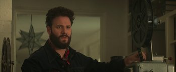 Movie still from “Zeroville” (2019), directed by James Franco – A man with a goatee is holding a camera; Close Up shot, Over the shoulder angle