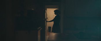 Movie still from “Zoe” (2018), directed by Drake Doremus – A woman standing in front of an open refrigerator; Medium shot, Over the shoulder angle