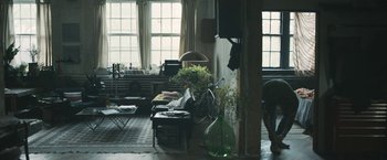 Movie still from “Zoe” (2018), directed by Drake Doremus – A living room filled with lots of furniture and plants; Wide shot, High angle