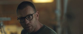 Movie still from “Zoe” (2018), directed by Drake Doremus – A person wearing glasses; Close Up shot, Over the shoulder angle