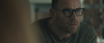 Movie still from “Zoe” (2018), directed by Drake Doremus – A person wearing glasses; Close Up shot, Over the shoulder angle