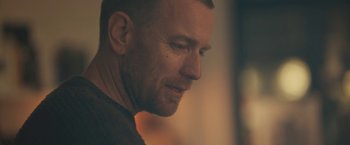 Movie still from “Zoe” (2018), directed by Drake Doremus – A man's face in a dark room; Close Up shot, Over the shoulder angle