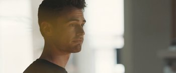 Movie still from “Zoe” (2018), directed by Drake Doremus – A man's face in front of a window; Close Up shot, Over the shoulder angle