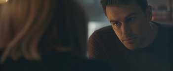 Movie still from “Zoe” (2018), directed by Drake Doremus – A man sitting in front of a laptop computer in a dark room; Close Up shot, Over the shoulder angle