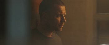 Movie still from “Zoe” (2018), directed by Drake Doremus – A person looking to his left; Close Up shot, Low angle