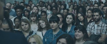Movie still from “Zoe” (2018), directed by Drake Doremus – A group of people standing in a room; Close Up shot, High angle
