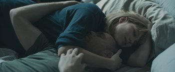 Movie still from “Zoe” (2018), directed by Drake Doremus – A man and a woman laying in a bed together; Close Up shot, High angle