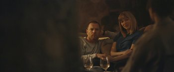 Movie still from “Zoe” (2018), directed by Drake Doremus – A man and a woman sitting at a table with wine glasses; Medium shot, Over the shoulder angle