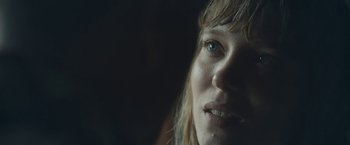 Movie still from “Zoe” (2018), directed by Drake Doremus – A woman's face in the dark; Extreme Close Up shot, Low angle
