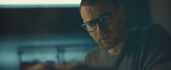 Movie still from “Zoe” (2018), directed by Drake Doremus – A person wearing glasses looking at a computer screen; Close Up shot, Low angle