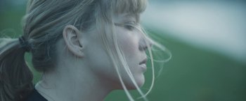 Movie still from “Zoe” (2018), directed by Drake Doremus – A woman's face with long blonde hair; Extreme Close Up shot, Low angle
