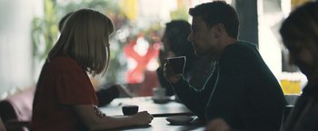Movie still from “Zoe” (2018), directed by Drake Doremus – A man and a woman sitting at a table drinking coffee; Medium shot, Over the shoulder angle