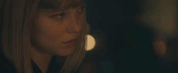 Movie still from “Zoe” (2018), directed by Drake Doremus – A woman's face in the dark; Close Up shot, Over the shoulder angle