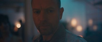 Movie still from “Zoe” (2018), directed by Drake Doremus – A person wearing a shirt; Close Up shot, Over the shoulder angle