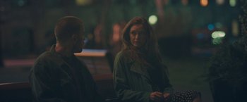 Movie still from “Zoe” (2018), directed by Drake Doremus – A woman is sitting on a park bench next to a man; Medium shot, Over the shoulder angle