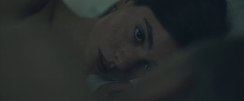 Movie still from “Zoe” (2018), directed by Drake Doremus – A person laying in a bed; Extreme Close Up shot, High angle