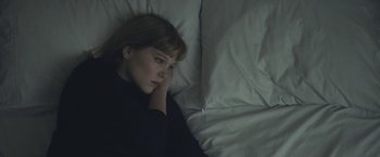 Movie still from “Zoe” (2018), directed by Drake Doremus – A woman laying in a bed with her head resting on a pillow; Close Up shot, High angle