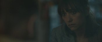 Movie still from “Zoe” (2018), directed by Drake Doremus – A young woman is staring at the camera; Close Up shot, Over the shoulder angle
