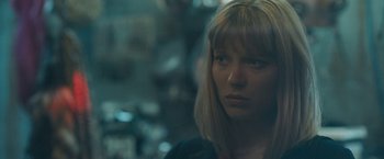 Movie still from “Zoe” (2018), directed by Drake Doremus – A person wearing a black shirt; Close Up shot, Over the shoulder angle