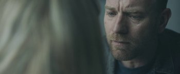 Movie still from “Zoe” (2018), directed by Drake Doremus – A man's face looking at the camera; Close Up shot, Over the shoulder angle