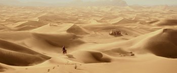 Movie still from “Zoolander 2” (2016), directed by Ben Stiller – A man riding a horse through the desert; Extreme Wide shot, High angle