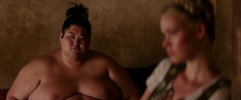 Movie still from “Zoolander 2” (2016), directed by Ben Stiller – A man and a woman sitting next to each other on a couch; Close Up shot, Over the shoulder angle