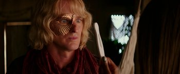 Movie still from “Zoolander 2” (2016), directed by Ben Stiller – A man with a knife in his hand and a mask on his face; Close Up shot, Over the shoulder angle