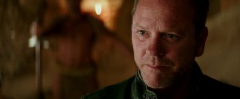 Movie still from “Zoolander 2” (2016), directed by Ben Stiller – A man's face in front of a blurry background; Close Up shot, Over the shoulder angle