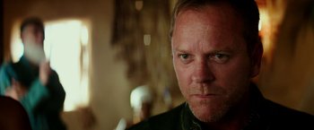 Movie still from “Zoolander 2” (2016), directed by Ben Stiller – A man's face in a dark room; Close Up shot, Over the shoulder angle